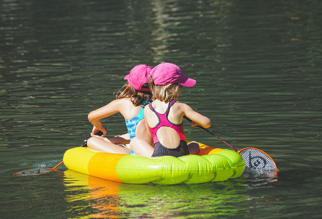 Children enjoying time together by the lake